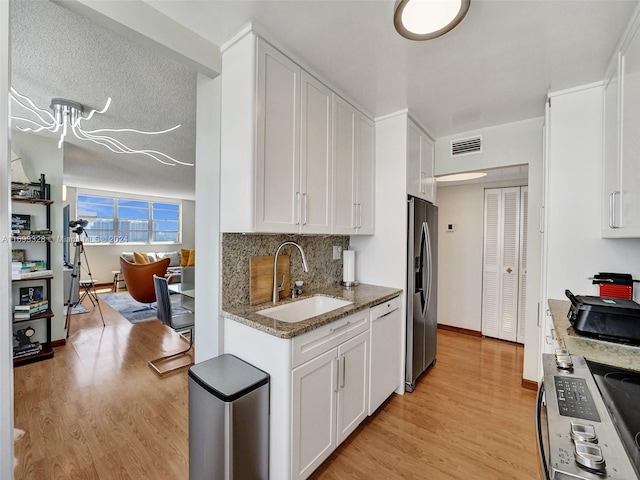 1833 S Ocean Dr Unit 1702, Hallandale Beach, FL 33009 - kitchen featuring a sink, appliances with stainless steel finishes, light wood-type flooring, and white cabinetry