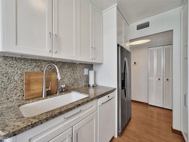 1833 S Ocean Dr Unit 1702, Hallandale Beach, FL 33009 - kitchen featuring dishwasher, a sink, white cabinetry, and light stone countertops
