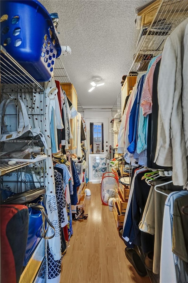 walk in closet featuring light hardwood / wood-style flooring