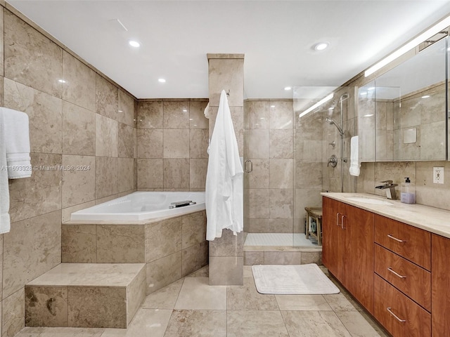 bathroom featuring vanity, plus walk in shower, tile walls, and tile patterned floors