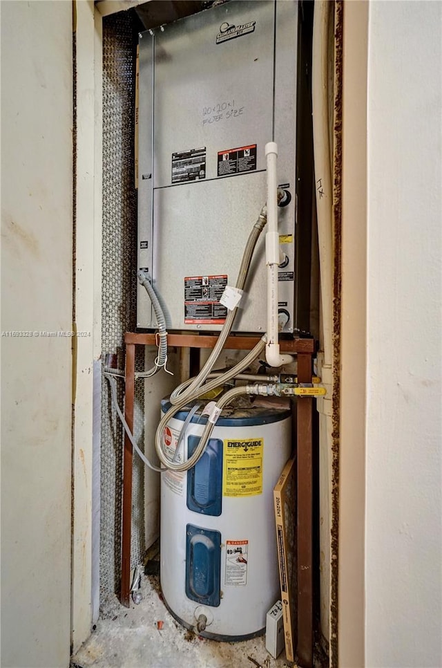 utility room featuring water heater and heating unit