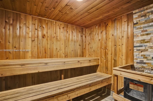 view of sauna with wood walls, wooden ceiling, and hardwood / wood-style floors