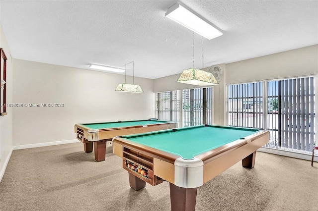 recreation room with a textured ceiling, pool table, and light carpet