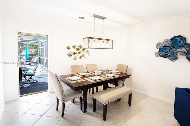 dining area with light tile patterned flooring and ornamental molding