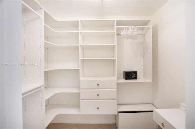 walk in closet with tile patterned floors