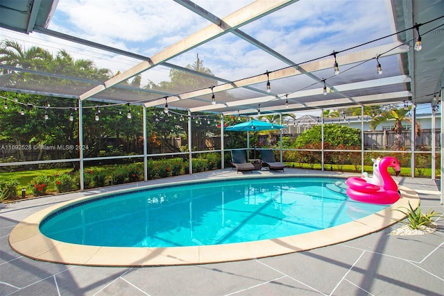 view of pool featuring a lanai and a patio area