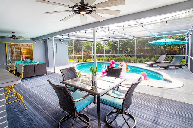 view of swimming pool with glass enclosure and a patio