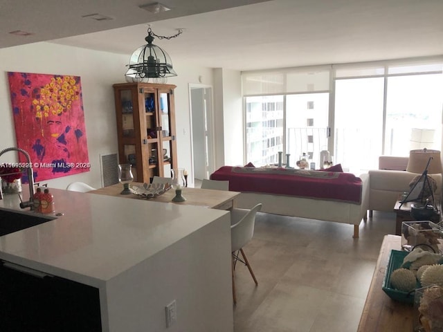 dining space featuring an inviting chandelier and a wall of windows