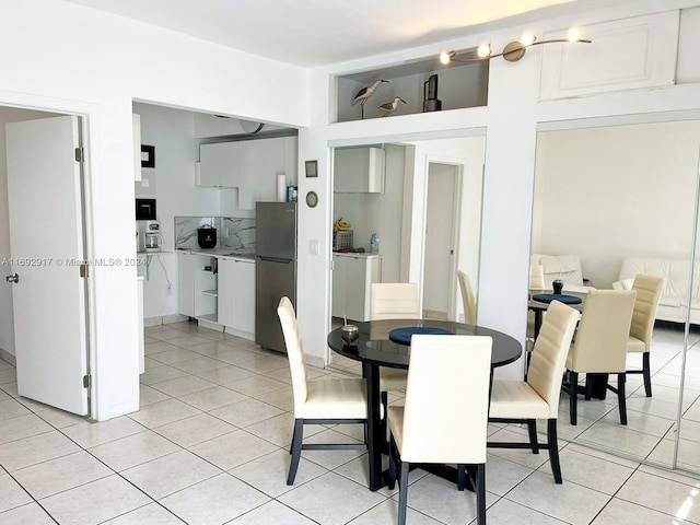 dining area featuring light tile patterned flooring