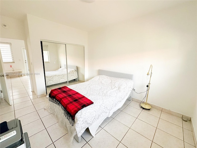 tiled bedroom with a closet