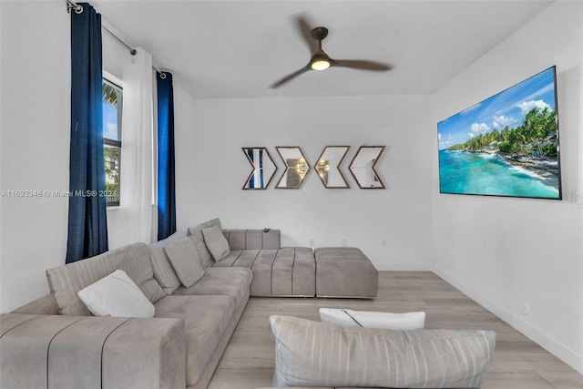 living room featuring light hardwood / wood-style floors and ceiling fan