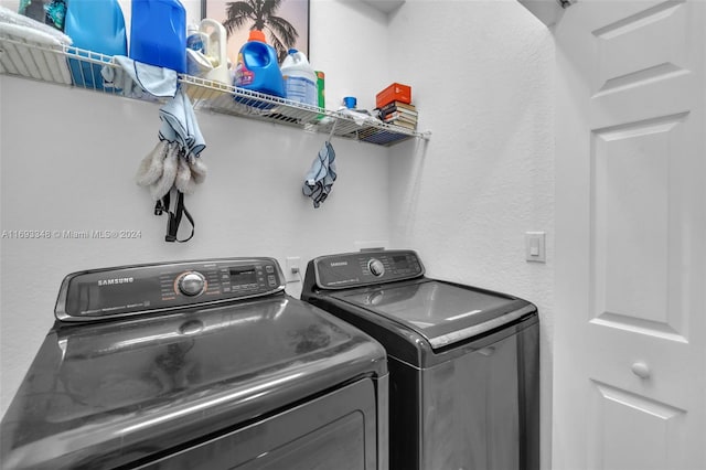 clothes washing area with washing machine and clothes dryer