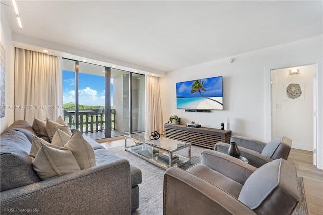 90 Edgewater Dr Unit 1015, Coral Gables, FL 33133 - living area with wood finished floors, expansive windows, and baseboards