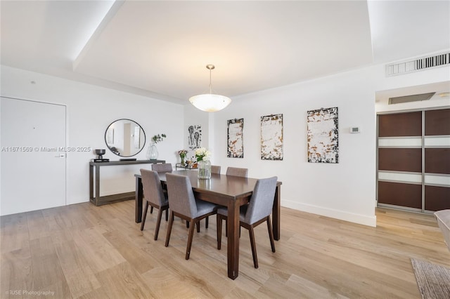 dining room with light wood finished floors and baseboards