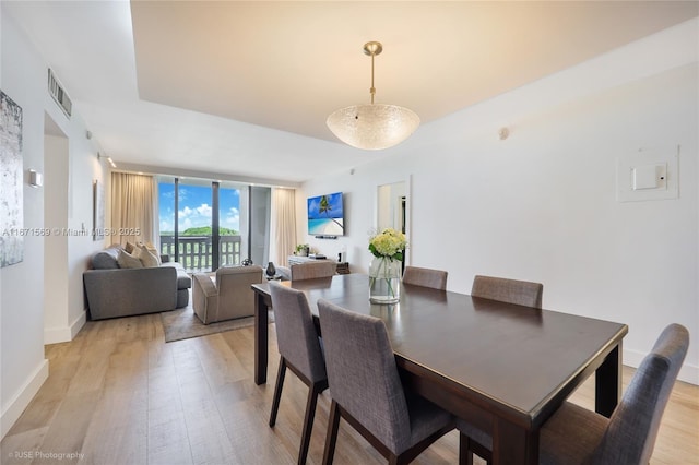 90 Edgewater Dr Unit 1015, Coral Gables, FL 33133 - dining room featuring light wood-style flooring, floor to ceiling windows, and baseboards