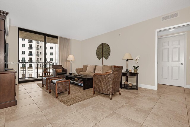 living room featuring light tile patterned floors and floor to ceiling windows