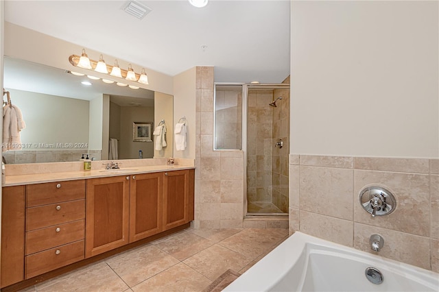 bathroom featuring vanity, tile patterned floors, shower with separate bathtub, and tile walls