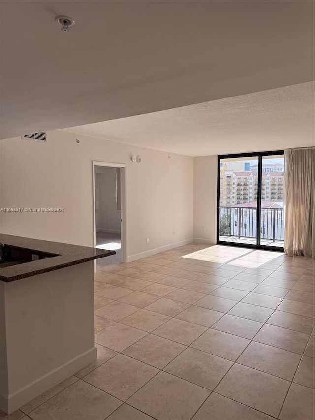 tiled empty room with expansive windows