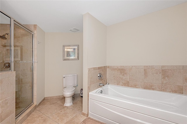 bathroom with tile patterned flooring, toilet, and shower with separate bathtub