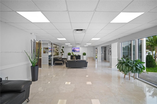 living room featuring a paneled ceiling