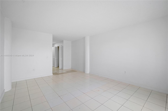 spare room featuring light tile patterned flooring