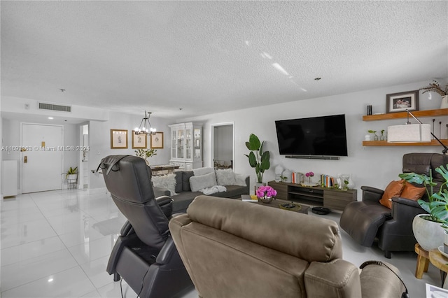 living room featuring light tile patterned flooring, a textured ceiling, and an inviting chandelier