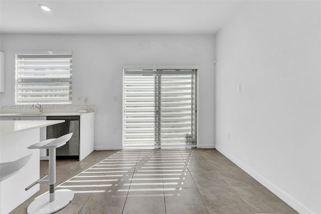 unfurnished dining area with tile patterned flooring and sink