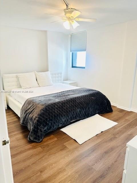 bedroom featuring hardwood / wood-style floors and ceiling fan