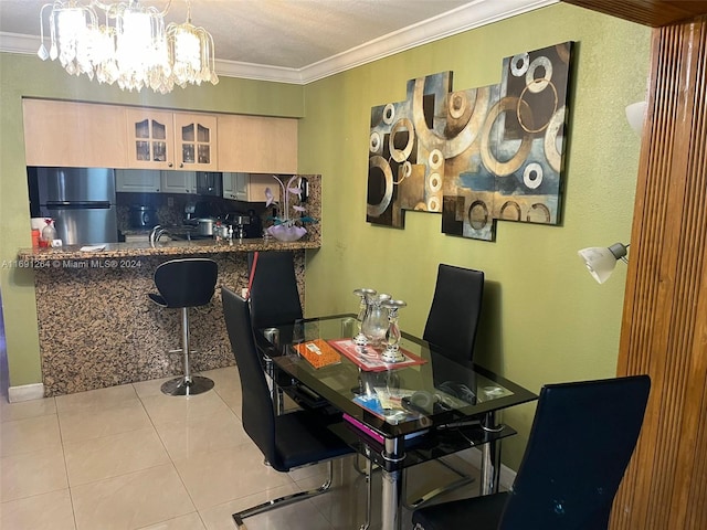 tiled dining space featuring a chandelier and crown molding