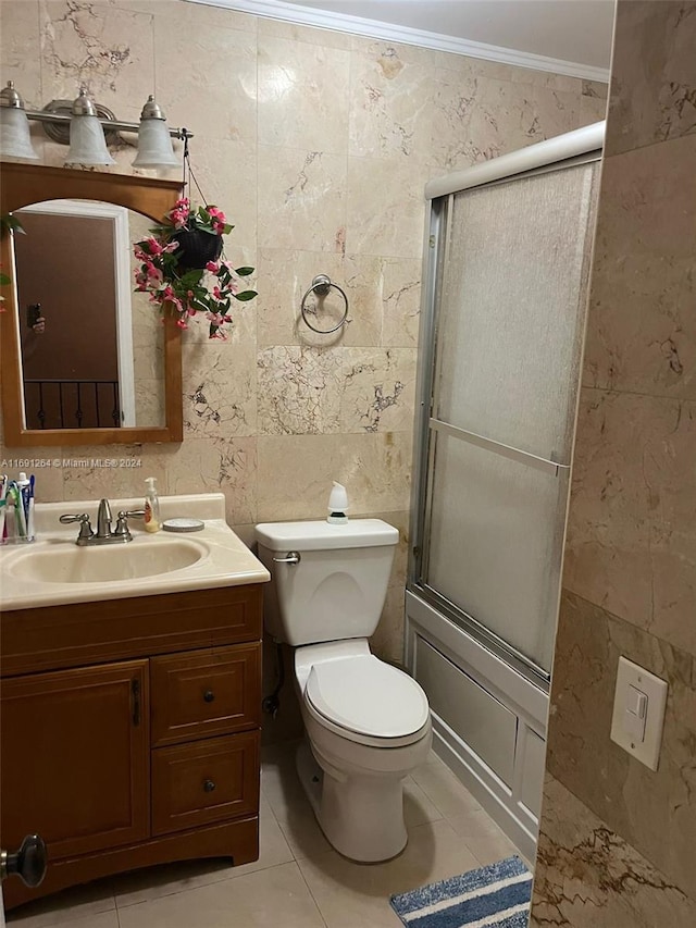 full bathroom with tile walls, enclosed tub / shower combo, tile patterned floors, crown molding, and vanity