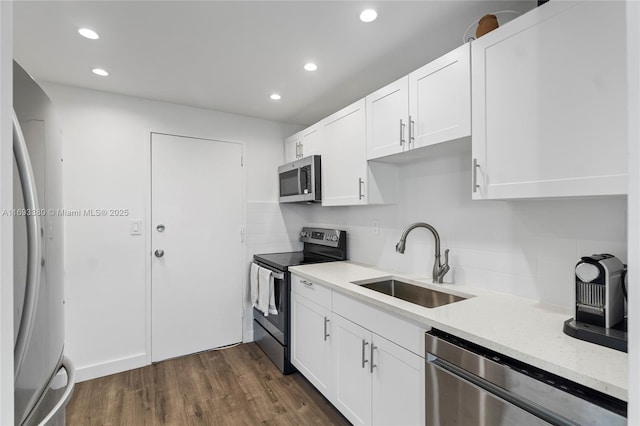 kitchen with sink, white cabinetry, stainless steel appliances, and tasteful backsplash