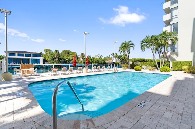 9800 W Bay Harbor Dr Unit 512, Bay Harbor Islands, FL 33154 - view of patio featuring a community pool and fence