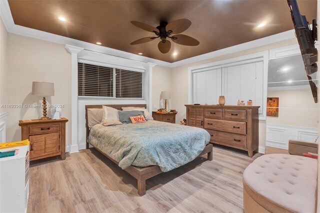 bedroom with light wood-type flooring, ceiling fan, and ornamental molding