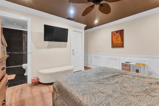 bedroom with ensuite bathroom, ceiling fan, wood-type flooring, and ornamental molding