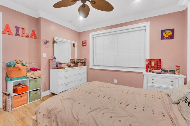 bedroom featuring ceiling fan, light hardwood / wood-style floors, and ornamental molding