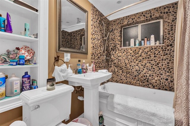 bathroom with toilet, shower / bathtub combination, and ornamental molding