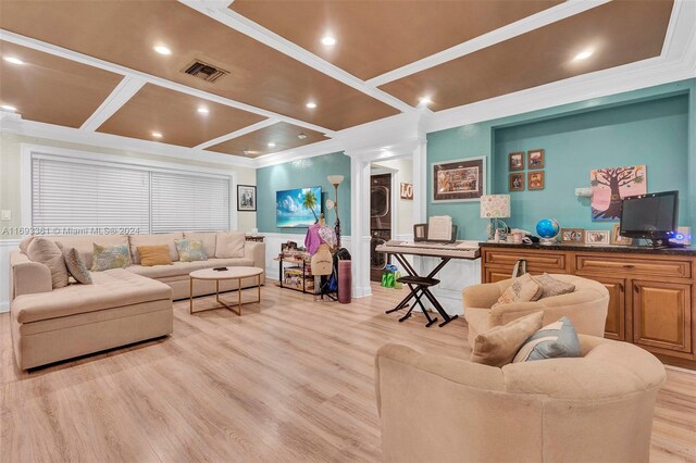 living room with crown molding, coffered ceiling, light hardwood / wood-style floors, and stacked washer and clothes dryer