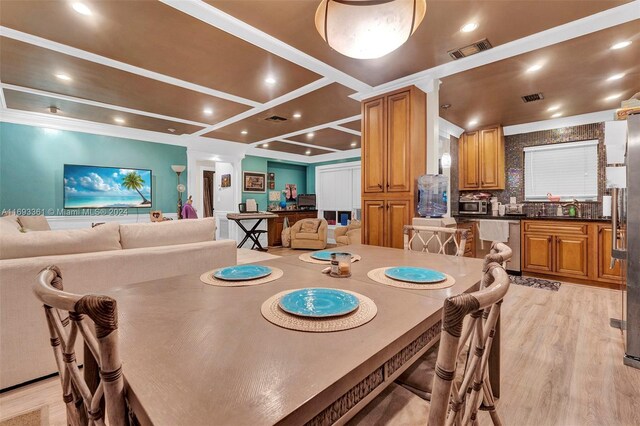 dining space featuring light wood-type flooring, crown molding, and coffered ceiling