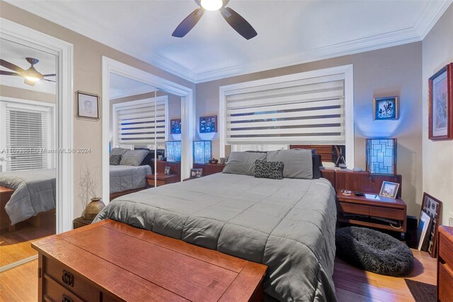 bedroom with wood-type flooring, ceiling fan, and ornamental molding