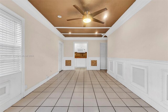 interior space featuring ceiling fan and ornamental molding