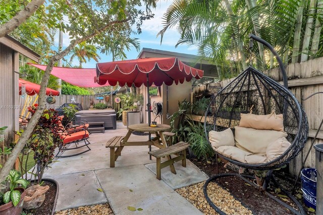 view of patio / terrace with a hot tub