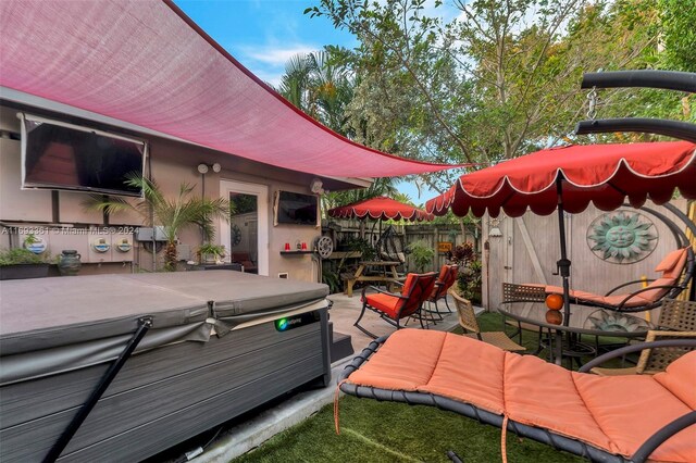 deck featuring a patio area and a hot tub