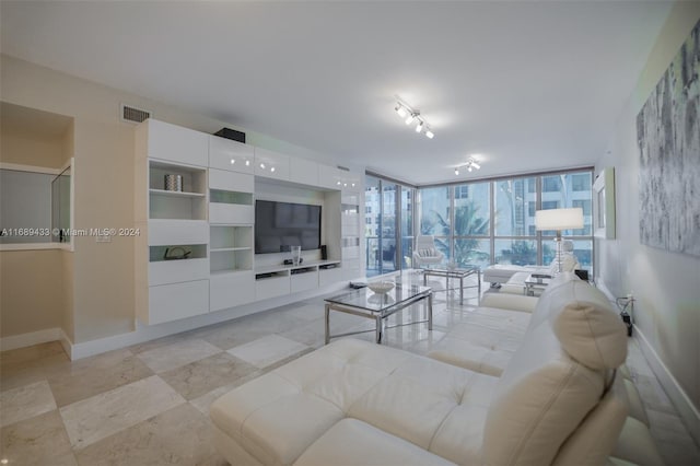 living room with track lighting and a wall of windows