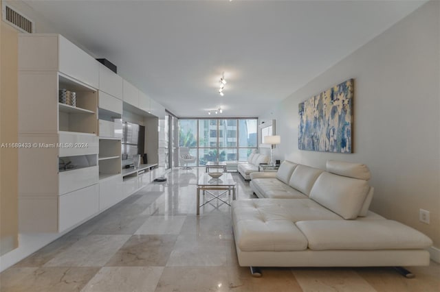 living room featuring floor to ceiling windows