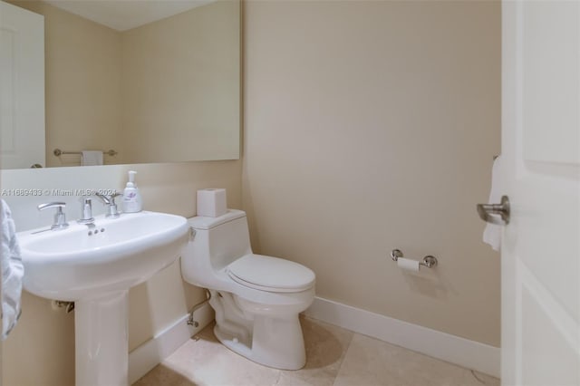 bathroom with tile patterned floors and toilet