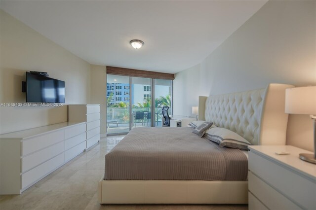 bedroom featuring access to exterior and floor to ceiling windows