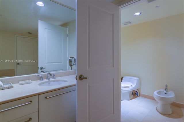 bathroom featuring vanity, toilet, and a bidet