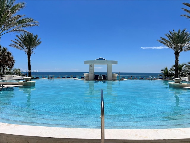 view of swimming pool with a water view