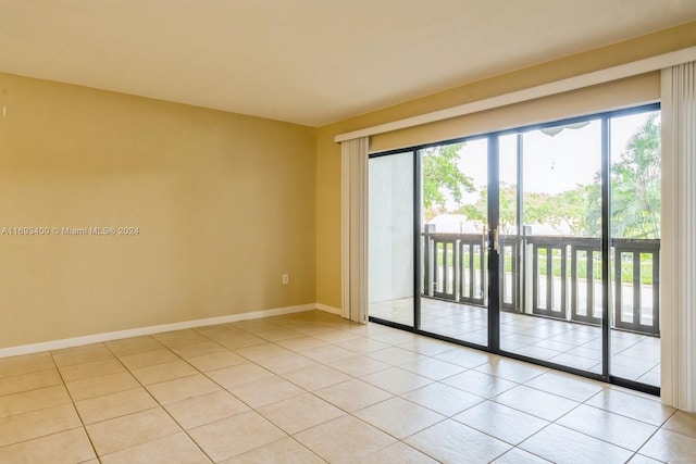 spare room with light tile patterned floors and a healthy amount of sunlight