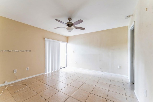 spare room featuring ceiling fan and light tile patterned flooring